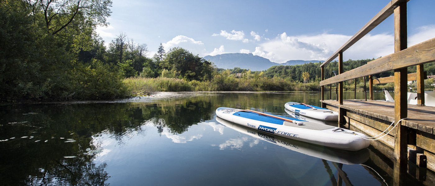 Hotel near Eppan an der Weinstraße: Gartenhotel Moser Calm lake with two stand-up paddleboards by a wooden dock