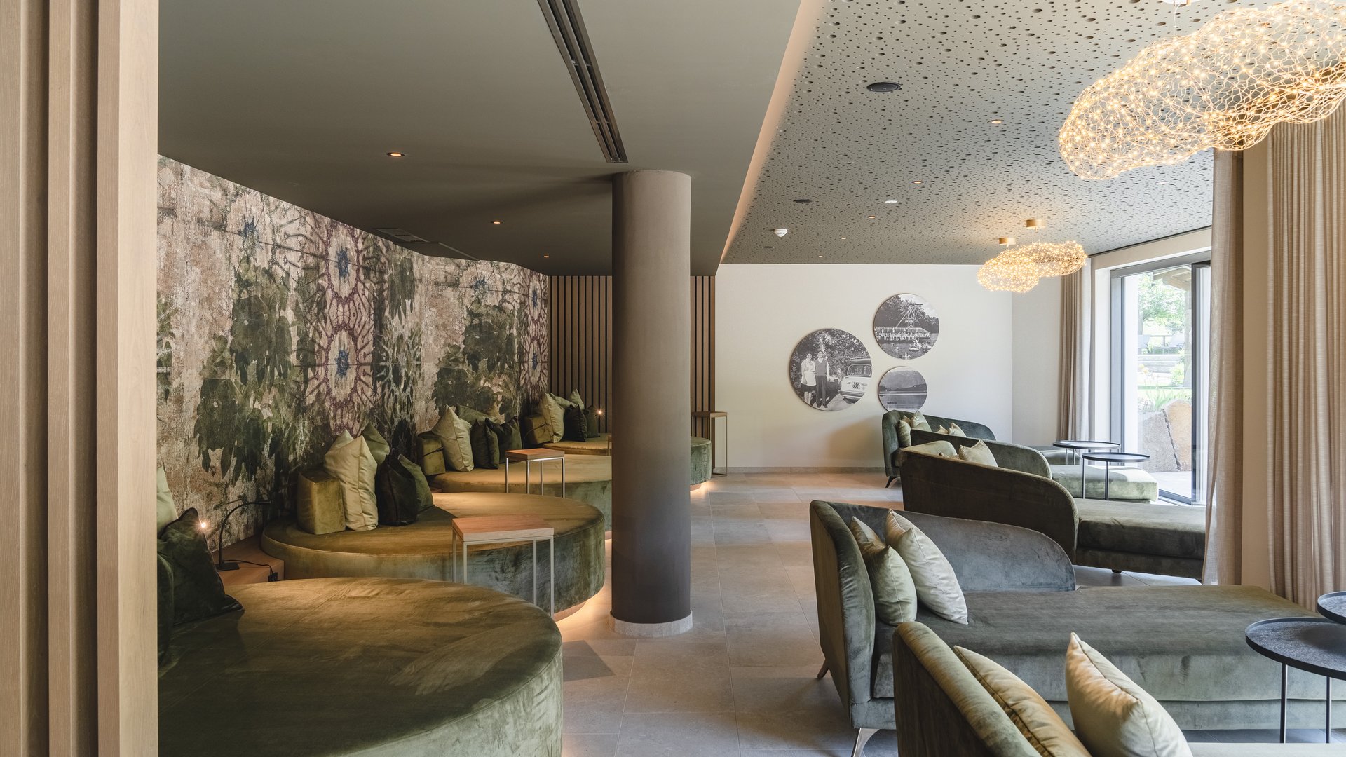 Hotel near Eppan an der Weinstraße: Gartenhotel Moser Cozy lounge area with green sofas and decorative wall in modern interior