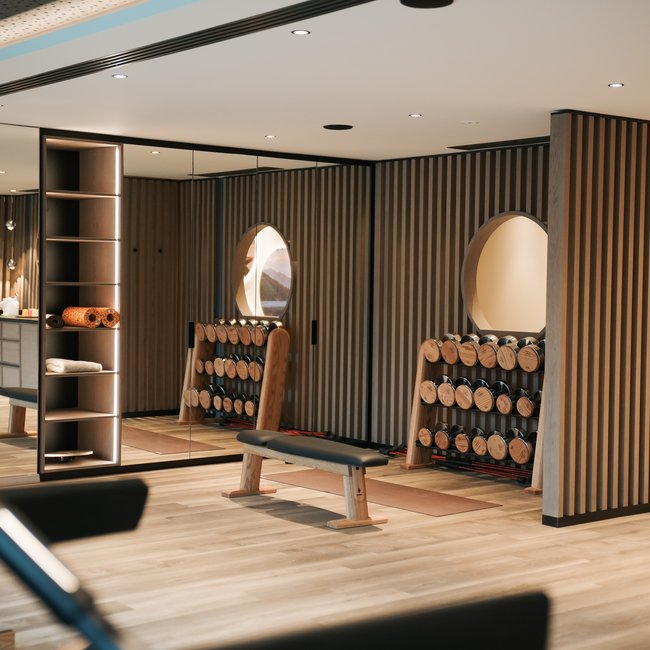 Sporthotel in Alto Adige: il Gartenhotel Moser Palestra moderna con pesi, panca e rivestimento in legno alle pareti