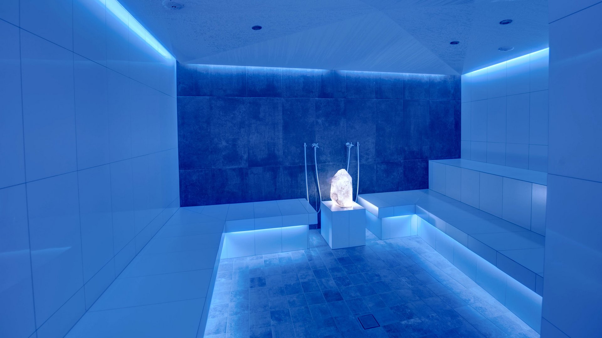 Wellness hotel with whirlpool and sauna world Modern steam room with blue LED lighting and crystal centerpiece
