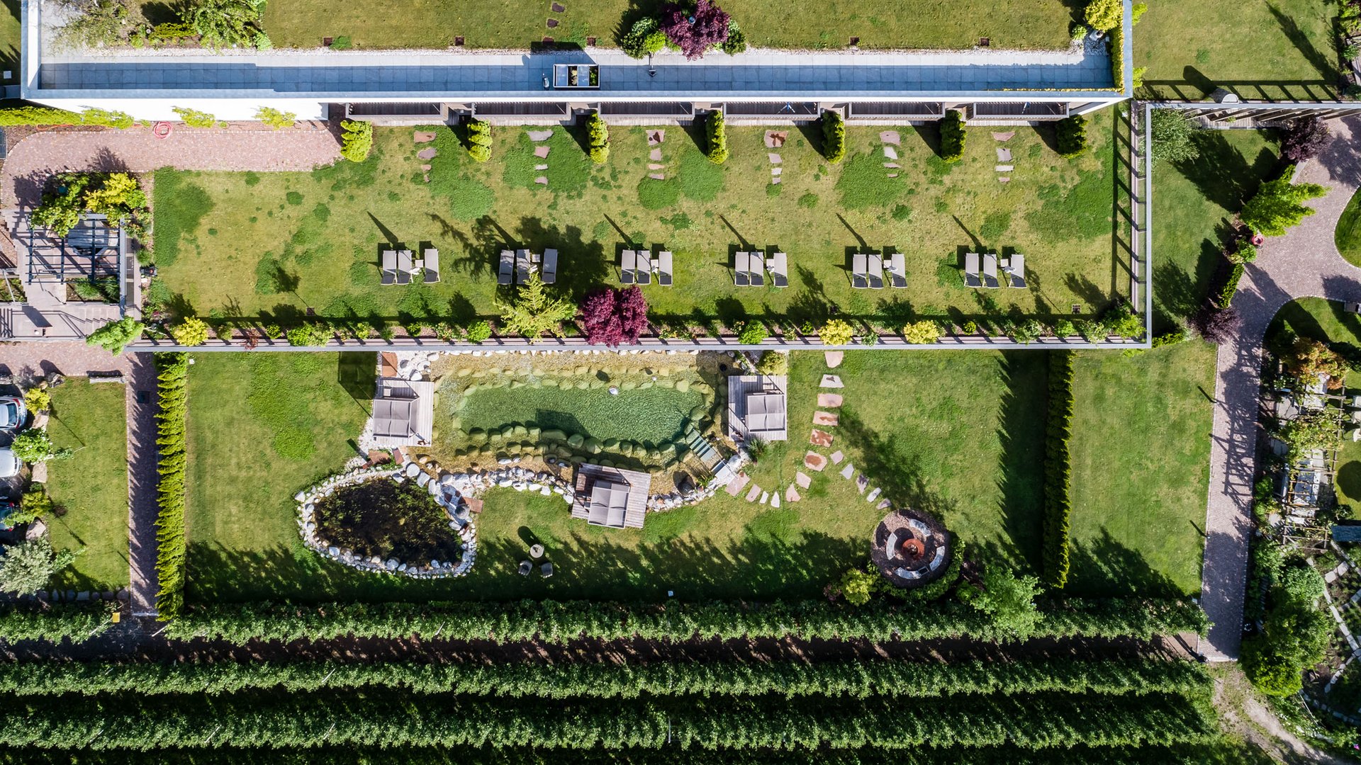 Hotel near Eppan an der Weinstraße: Gartenhotel Moser Aerial view of terrace apartments with garden and pond