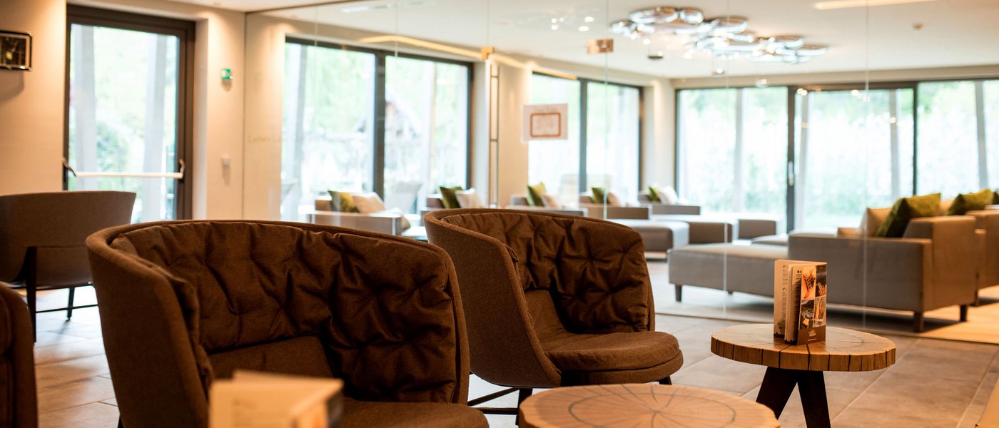Hotel near Eppan an der Weinstraße: Gartenhotel Moser Modern lounge with chairs and tables in front of a large mirror
