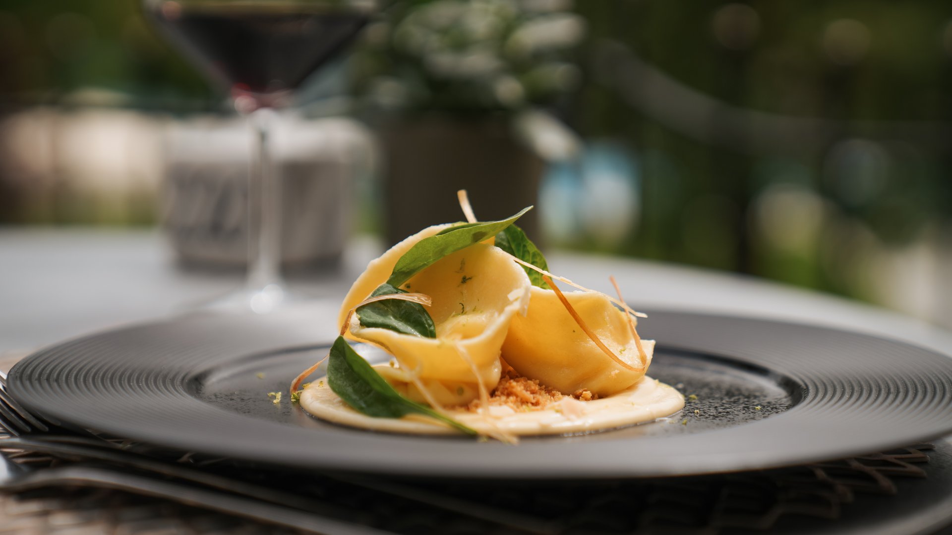 Hotel near Eppan an der Weinstraße: Gartenhotel Moser Gourmet pasta with green leaves on a black plate