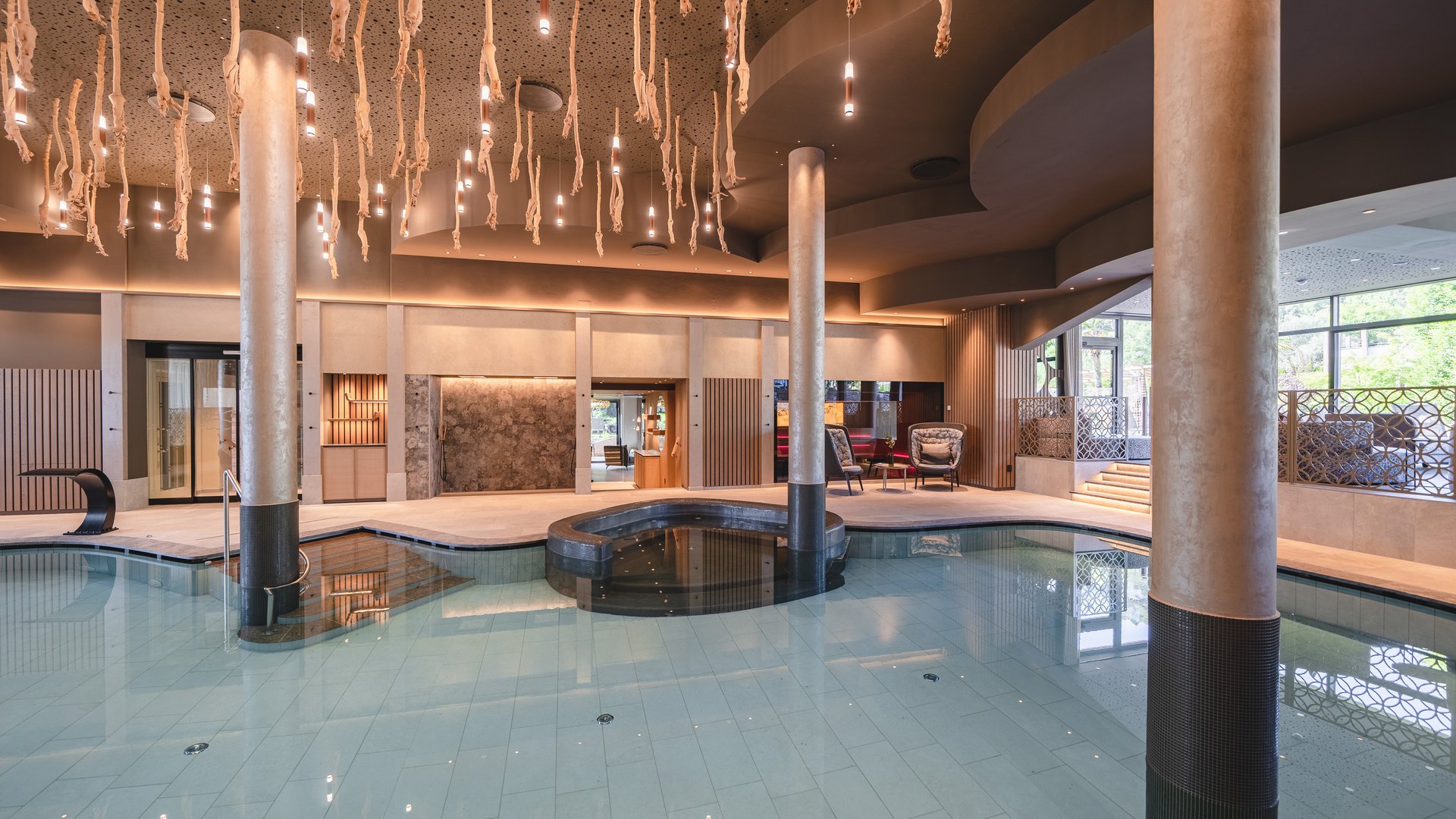 Hotel near Eppan an der Weinstraße: Gartenhotel Moser Modern indoor pool with columns and decorative ceiling lights