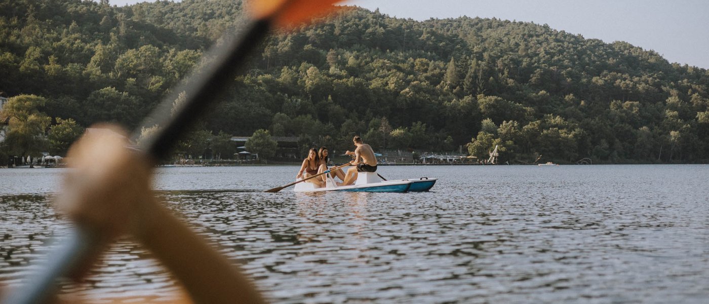 Hotel near Eppan an der Weinstraße: Gartenhotel Moser Person rowing with paddle on a lake with mountain view