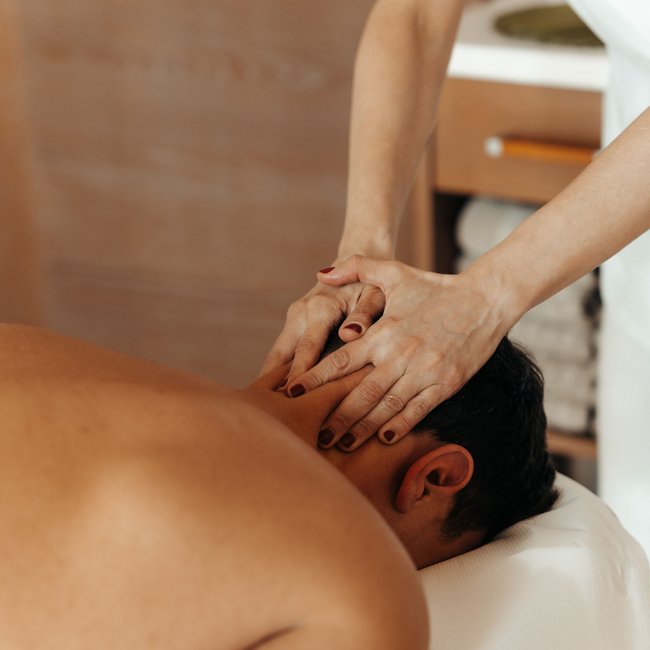 Hotel near Eppan an der Weinstraße: Gartenhotel Moser Man receiving neck massage at a wellness spa
